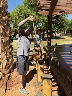 Workers pouring concrete for an outdoor bar countertop