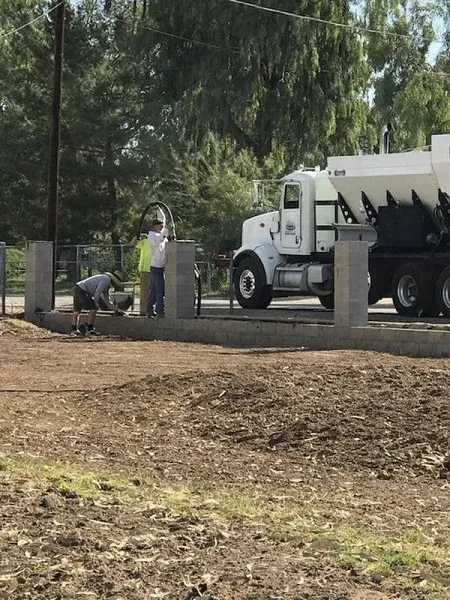 Concrete pump truck grouting a block wall