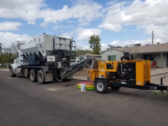 Volumetric mixer truck feeding a line pump trailer